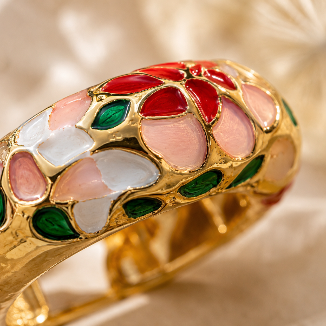 Extreme macro detail of gold-plated enamel hoop earring showing intricate red, pink, white, and green floral enamel work — House of Ruhira