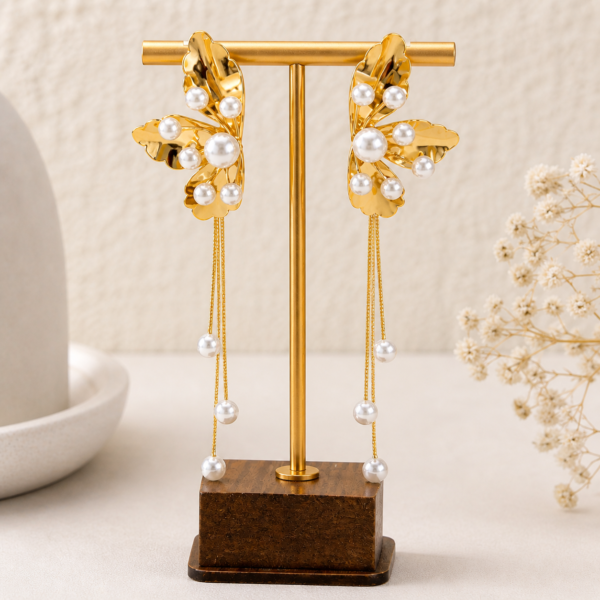 Golden pearl cascade earrings front view on stand — House of Ruhira