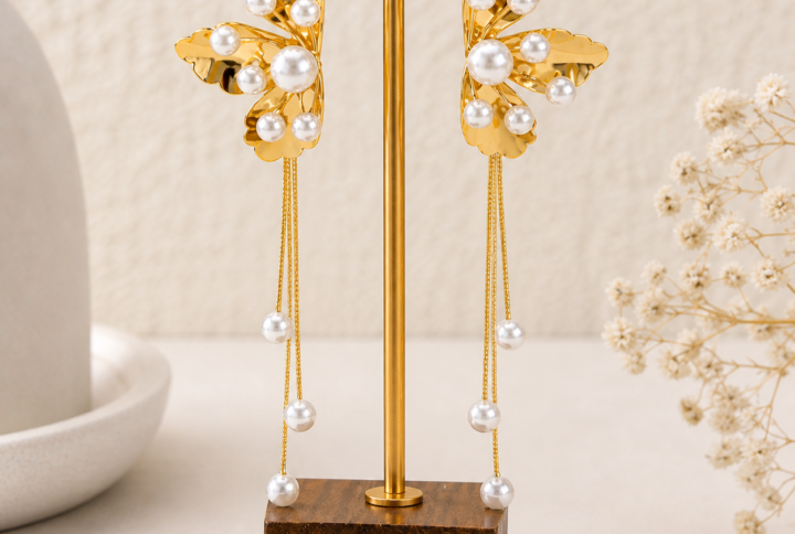 Golden pearl cascade earrings front view on stand — House of Ruhira