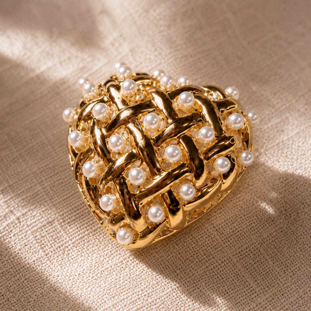 Flat lay styling of gold-toned heart-shaped stud earrings with woven lattice and faux pearls, styled with a silk scarf and dried botanicals — House of Ruhira