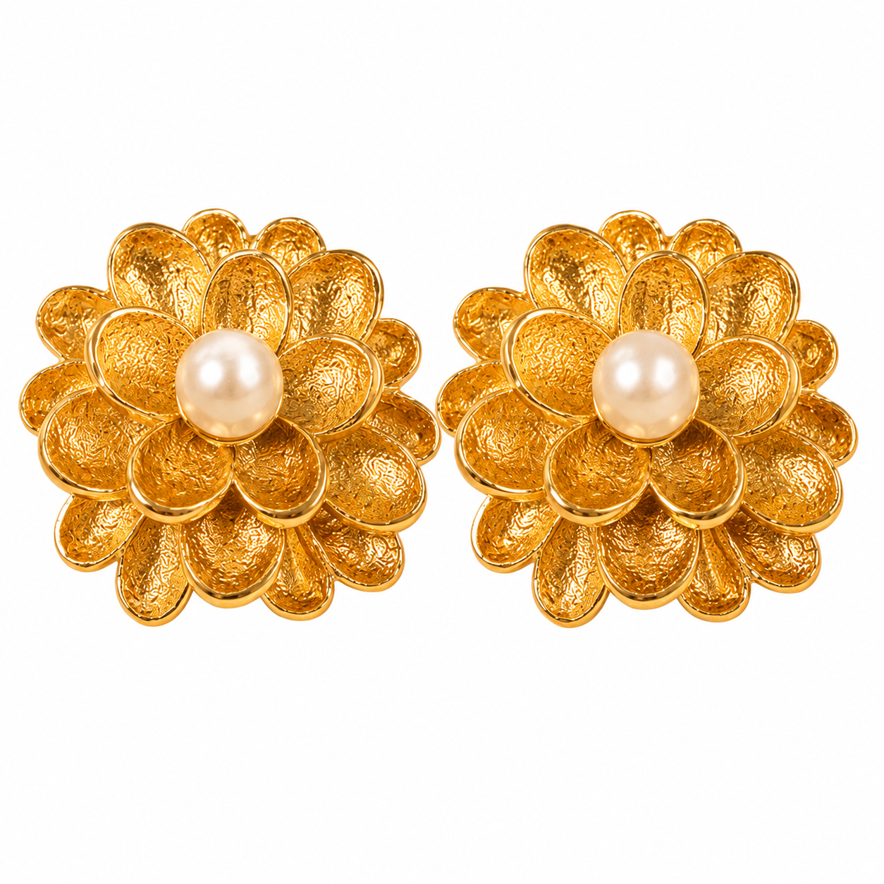 A flat lay styling of textured gold floral stud earrings with faux pearls, accompanied by a delicate scarf and dried botanicals on a light surface — House of Ruhira