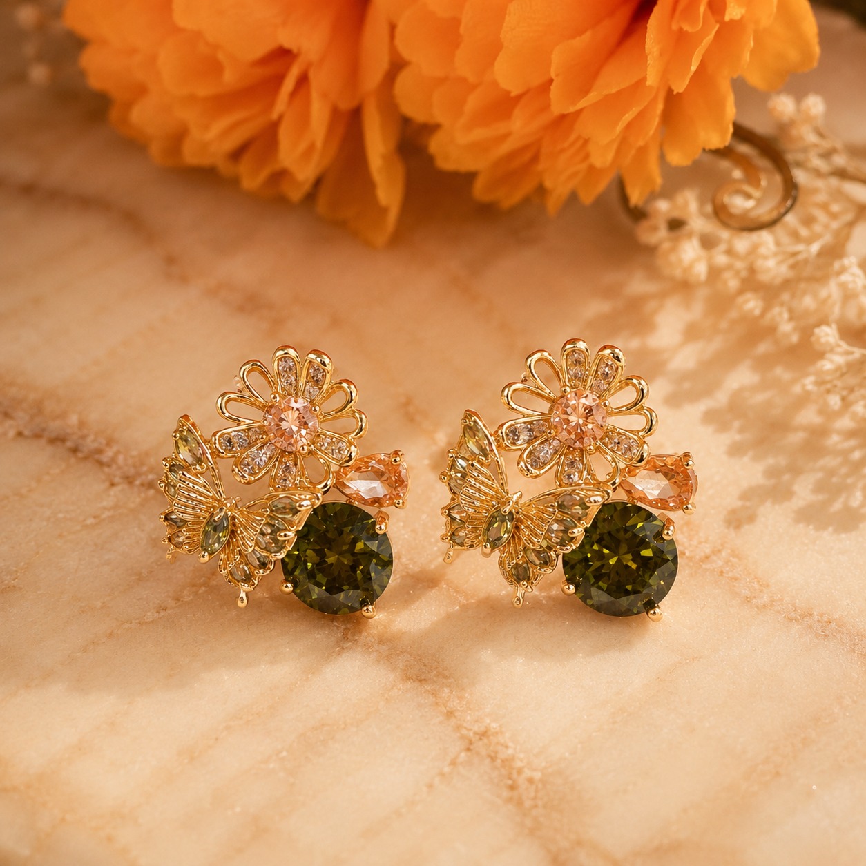Gold-plated floral and butterfly stud earrings with olive green, peach, and clear cubic zirconia on a clean white studio background — House of Ruhira