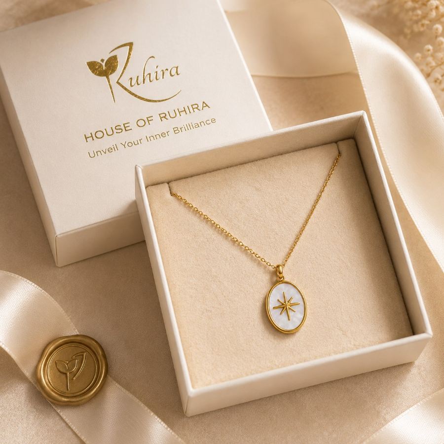 Flat lay styling of the gold chain necklace with Mother-of-Pearl starburst pendant, accompanied by a silk scarf and a small journal – House of Ruhira