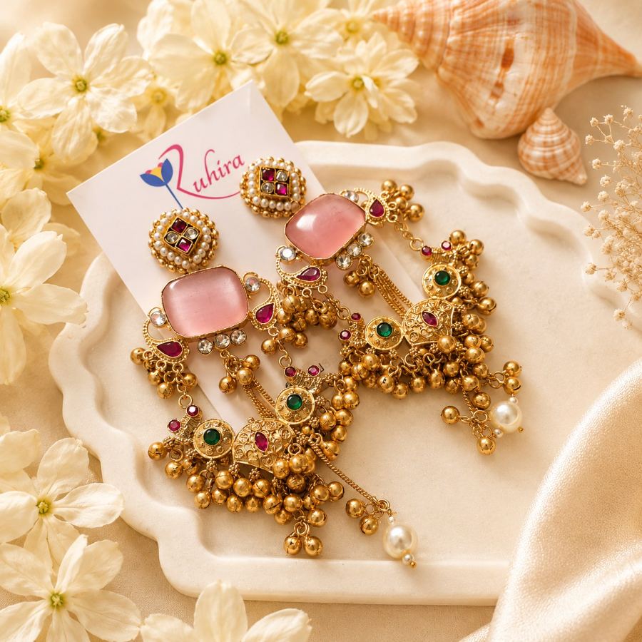 Flat lay styling of antique gold dangler earrings with pink, navy, and turquoise stones, arranged with traditional Indian props – House of Ruhira