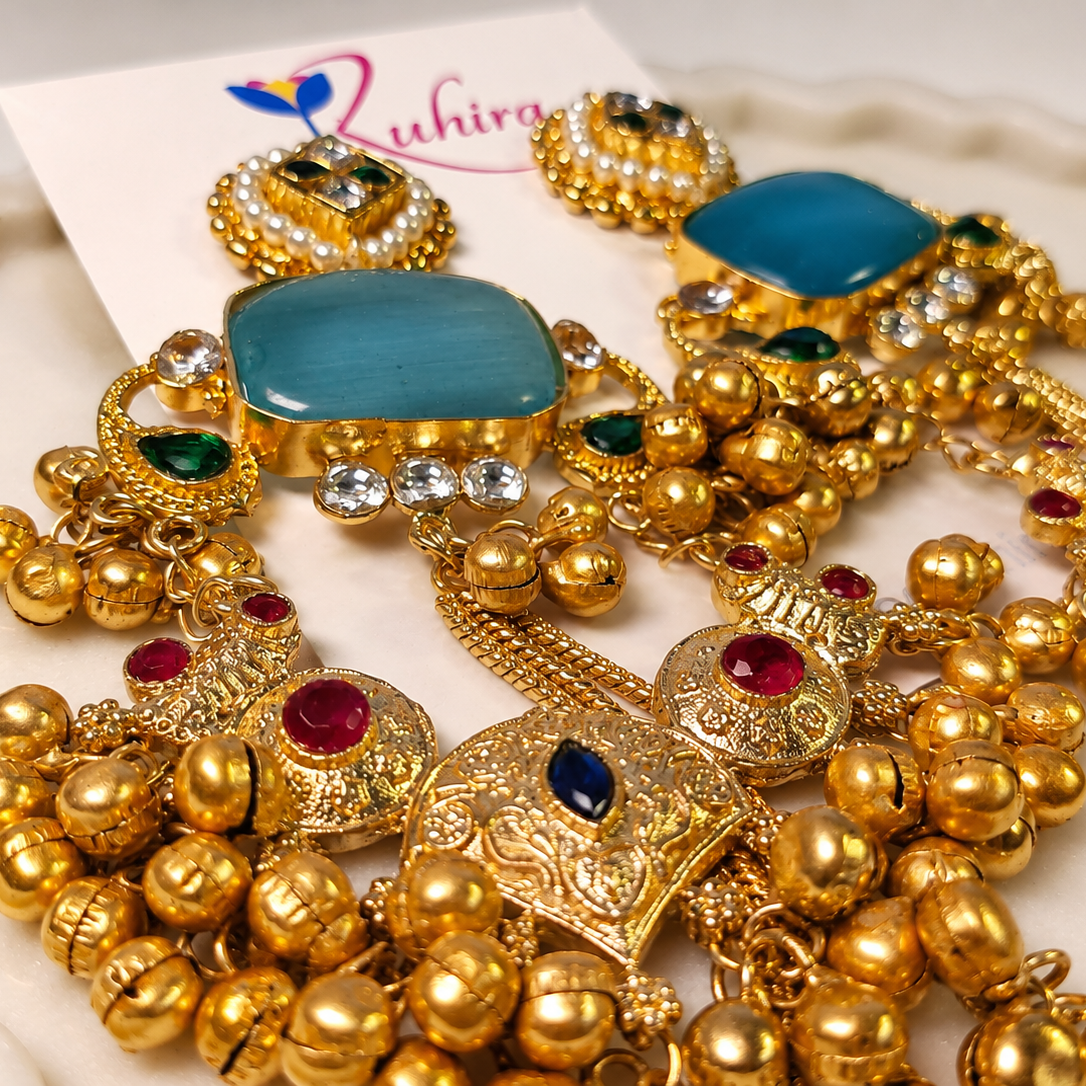 Extreme macro detail of the antique gold beadwork, kundan-style stones, and pearl clusters on the dangler earrings – House of Ruhira